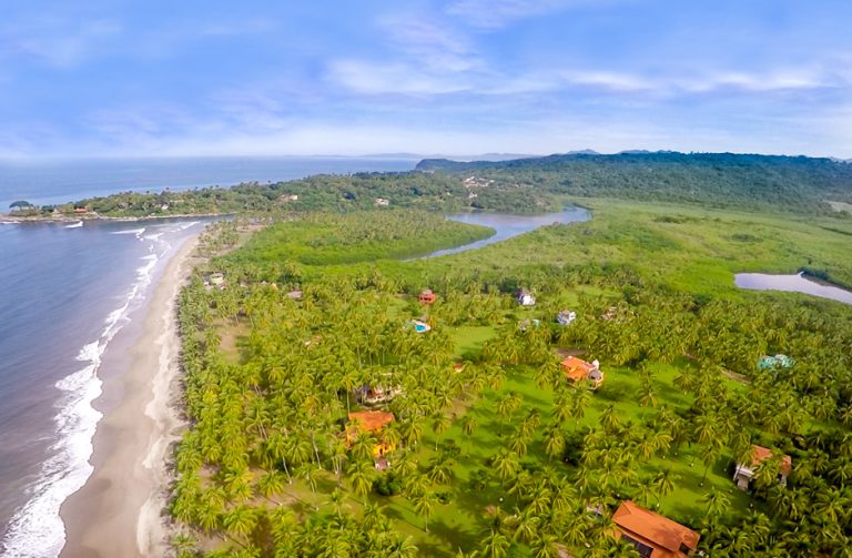 Aerial view of Playa Las Tortugas beachfront and lush green landscape in Riviera Nayarit, Mexico.